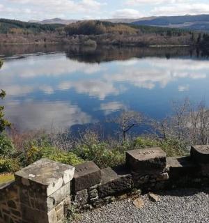 a view of a lake with a stone bench