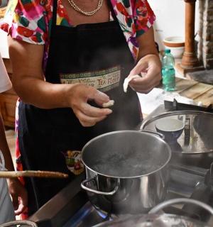 a woman stirring a pot in a kitchen