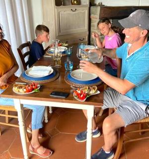 a group of people sitting around a wooden table