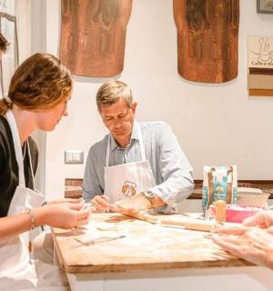 a group of people standing around a table preparing food