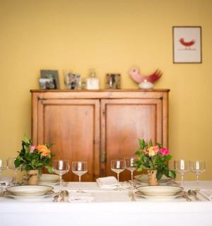 a table with plates and glasses and flowers on it