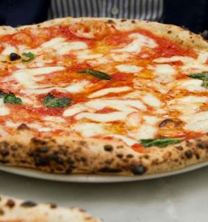a pizza sitting on a plate on a table