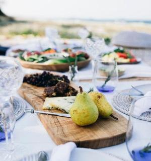 a table with plates of food and wine glasses