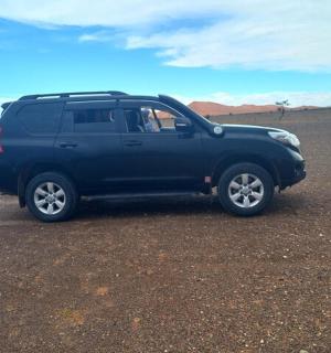 a blue pick up truck parked in the desert