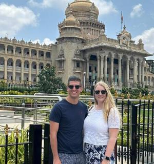 a man and woman standing in front of a building
