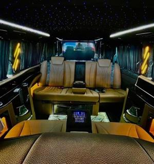 an inside view of a limousine with the back seat and tables and seats