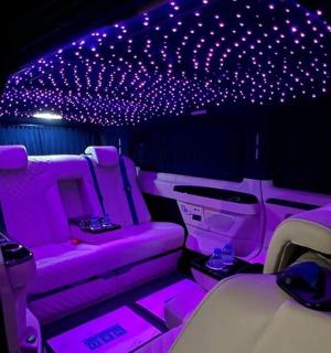 a purple limousine with purple lights in the back