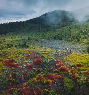 一群人在山上行走，山上有一座山