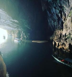 a cave with a boat in the water