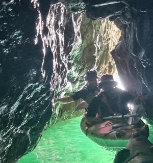 一群人坐在洞穴里的木筏上