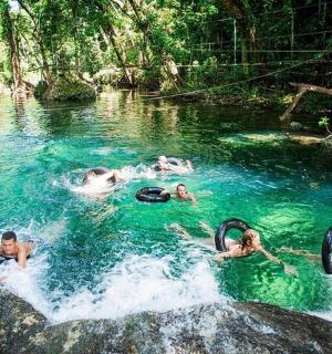 a group of people swimming in a river