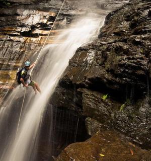 一名男子站在瀑布边