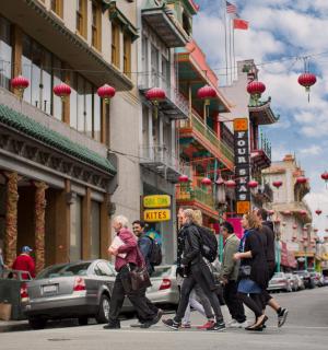 a group of people walking down a city street