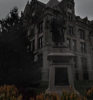 a large building with a statue in front of it