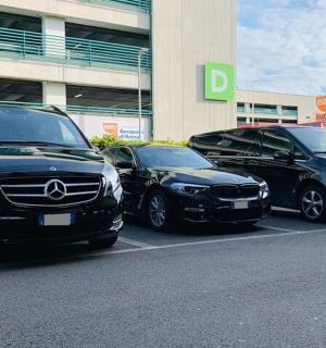 three cars parked in a parking lot in front of a building