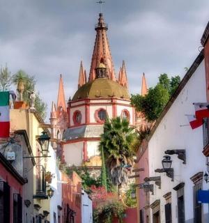 a building with a clock tower in the middle of a street