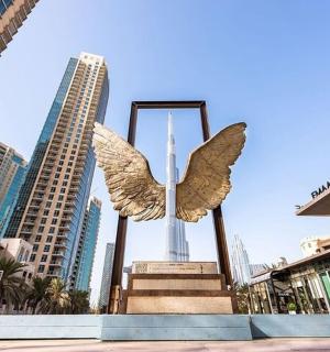 a statue of an angel in the middle of a city