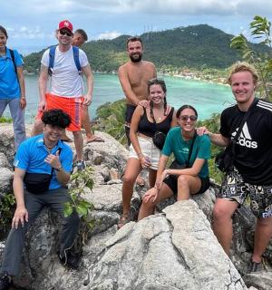 一群人坐在海滩附近的岩石上