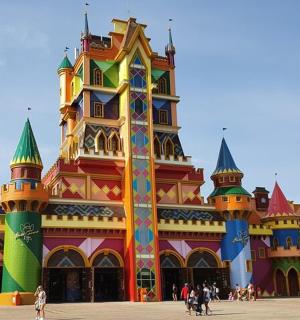 a colorful building with people walking in front of it