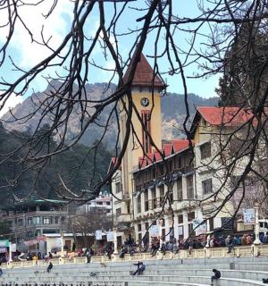 a large building with a clock tower in a town