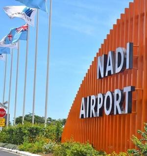 a sign for a nada airport with flags on it