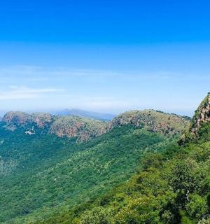 a view of a mountain range with trees and mountains