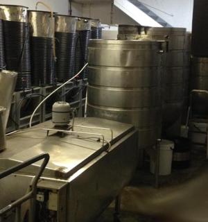 a kitchen with a bunch of wine barrels in a room