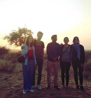 a group of people standing in the desert