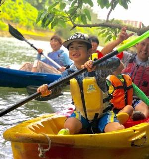 a group of people in a kayak on a river