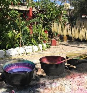 three buckets sitting on the ground in a garden