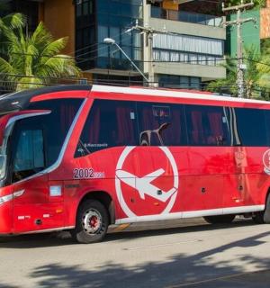 a red bus is parked on the street