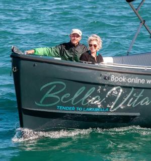 a man and woman sitting in a boat in the water