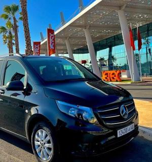 a blue car parked in front of a building