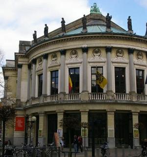 a large building with flags in front of it