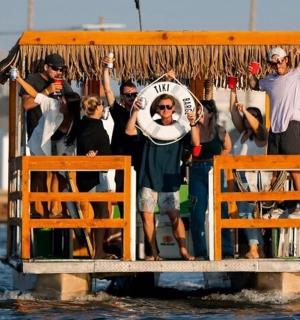 a group of people standing on a boat in the water