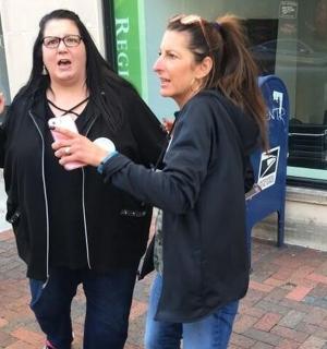 两个女人并排站着玩电子游戏