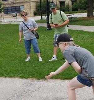 a group of three people standing in a park