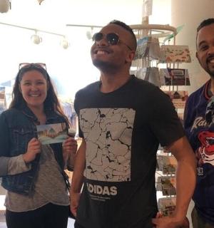 two men and a woman posing for a picture