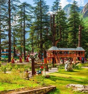 a playground in a park with trees and a building
