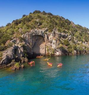 an island with people in kayaks in the water