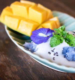 a plate of food with cheese and a flower on it