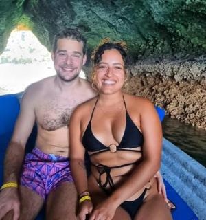 a man and a woman in a boat in a cave
