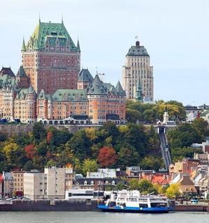 a city with tall buildings and a boat in the water