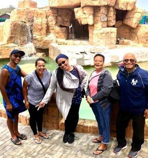 a group of people standing in front of a fountain