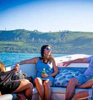a group of people sitting on the back of a boat