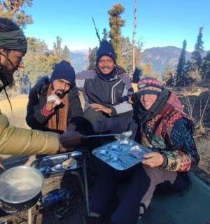 a group of people sitting around a grill