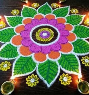 a rangoli of a flower on a table with lights