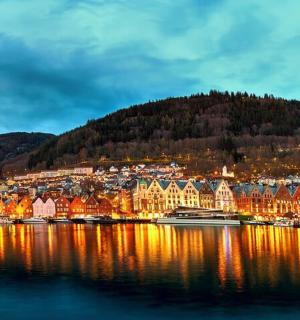 a town on the shore of a lake at night
