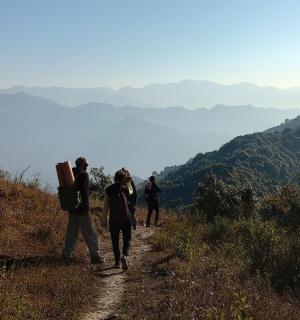 a group of people walking up a mountain trail