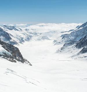 a snowy mountain range with snow covered mountains